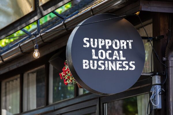 A small business signaling others to support their local SMBs.