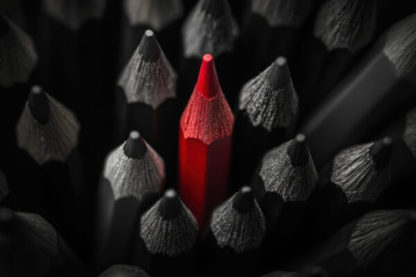 Red pencil among gray pencils. Stand out with your copy—make every word earn attention.