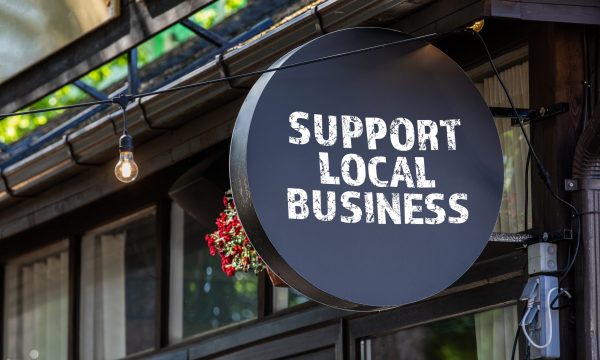 A small business signaling others to support their local SMBs.