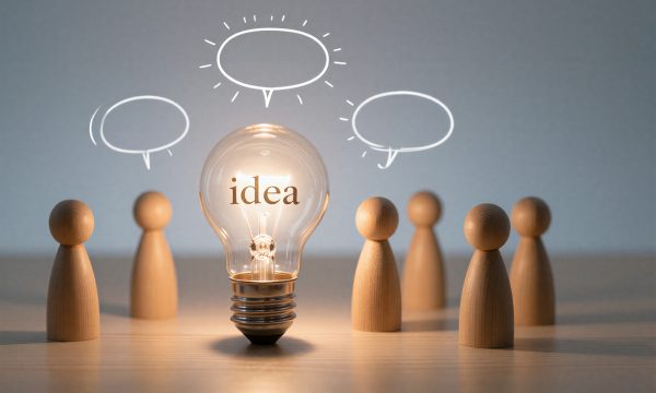 Light bulb with "idea" word, surrounded by wooden figures and speech bubbles --- depicting a thinking team.