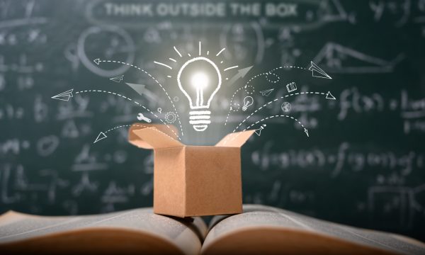 Think outside the box on a green blackboard. Startup, educational concept. Sparking creative ideas, change and growth.
