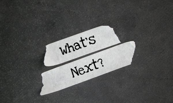 White sticker with the word question What's Next? Next step concept
